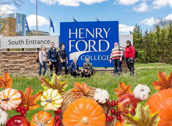 Image of students at HFC entrance sign with Thanksgiving overlay