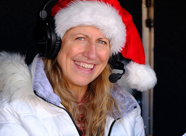 Susan McGraw broadcasts at the 61st Annual Garden City Downtown Development Authority Santaland Parade. 