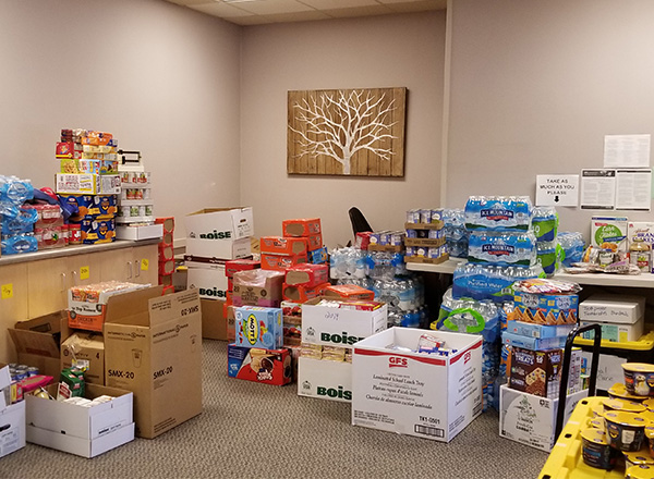A picture of the Hawks’ Nest pantry stocked with donations of food and bottled water.