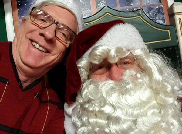 Rick Goward plays Santa Claus for the Dearborn Rotary Club. Randy Knight is with him. 