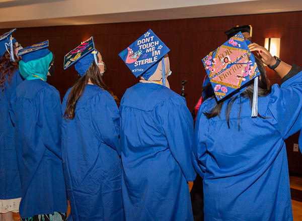 Graduates and their decorated caps.