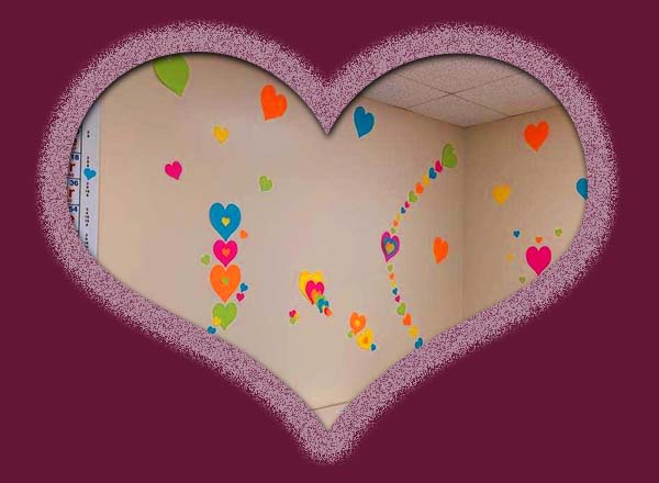 Hearts in a pattern on the wall, inside of a heart shape.