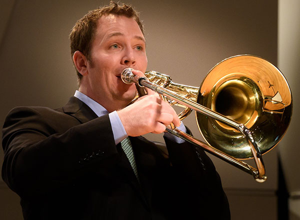 An image of Anthony Triplett playing the trombone. 