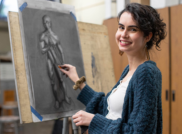 Female student drawing in the art studio. 