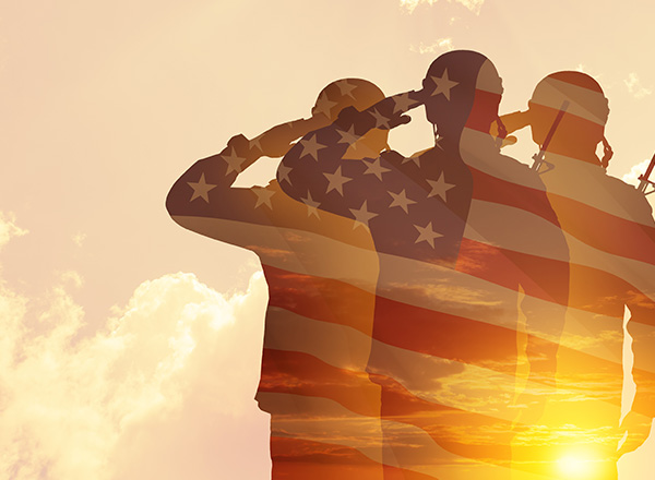 Silhouettes of soldiers with print of sunset and American flag.
