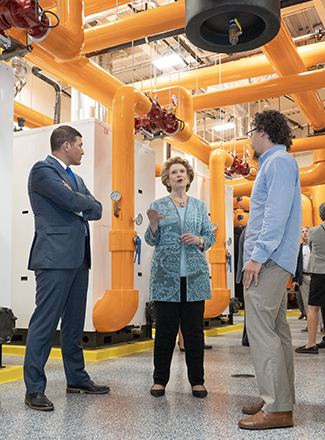 President Kavalhuna, Senator Stabenow, and Nicholas Paseiro tour the new HFC Energy Center. 