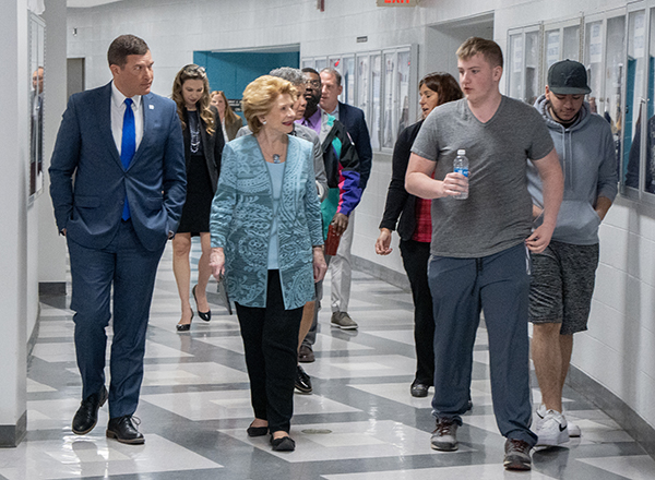 Senator Stabenow and HFC leaders talk with students as they prepare to tour the HFC Energy Center. 