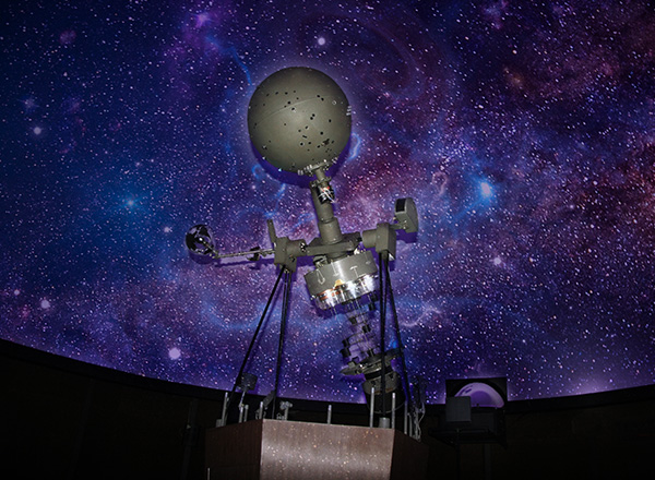 image of a space-age piece of equipment (satellite) with an outer space background