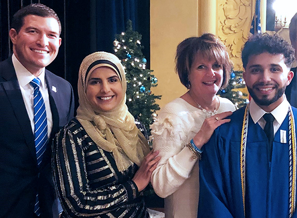 Ibrahim Saleh (far right), son of HFC Assistant Director, Student Conduct and Compliance and Title IX Coordinator Munira Kassim, graduated from HFC, earning his associate degree in nursing in 2019. From L-R: HFC President Russell Kavalhuna, Kassim, Dean of the HFC School of Health & Human Services Dr. Susan Shunkwiler (now retired), and Saleh. 