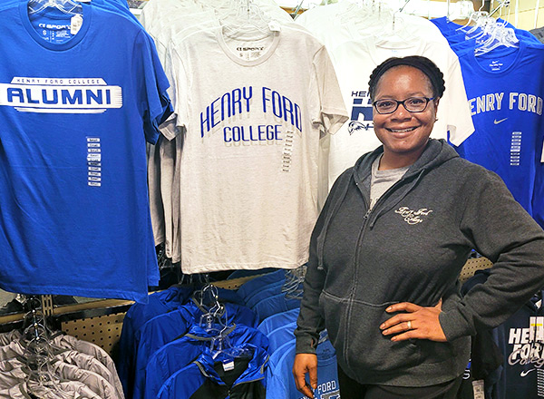 Shafyla Thompson stands in front of HFC shirts. 