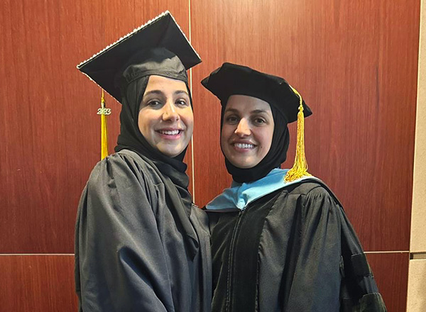 A picture of Zayneb Abu-Khader (left) and her mother Dr. Shayma Mustafa (right) in cap and gown. 