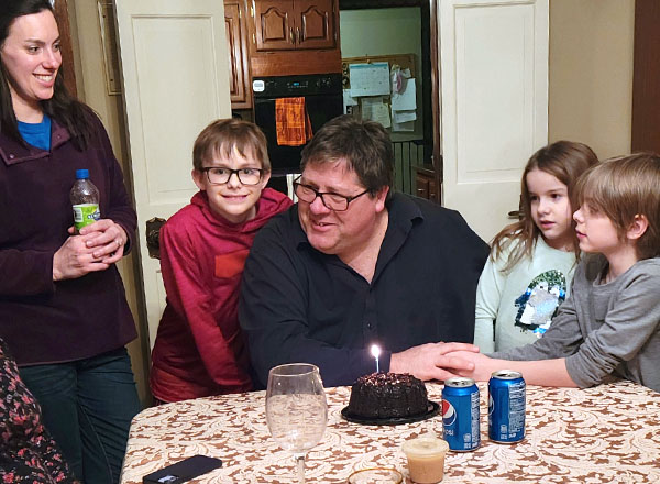 Surrounded by his family, G. Kevin Dewey celebrates a birthday. 