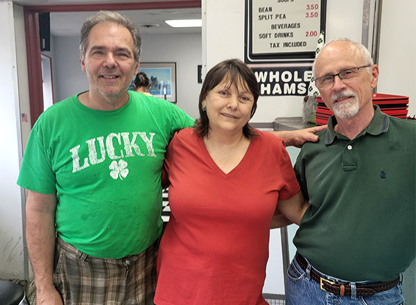 From L-R: Harry Lile poses with customers Dawn and Mark DeBlois. 