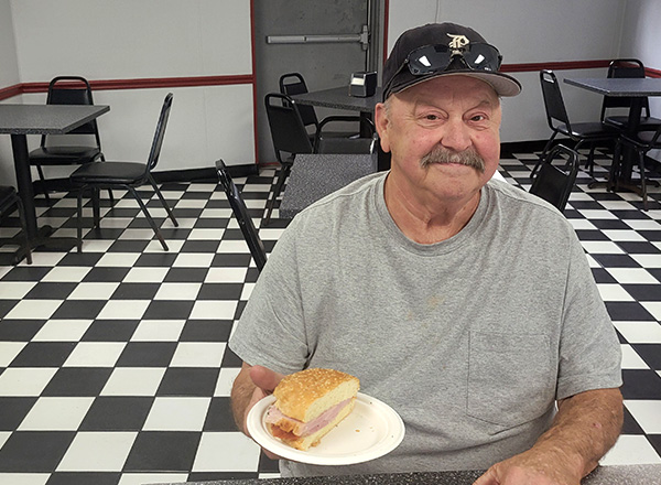 Ted Kowalski, a regular customer since Lile's opened its doors in 1965, shows off a ham sandwich.