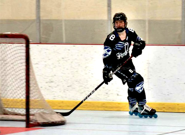 HFC roller hockey club player Kylie Brown skates behind the net.