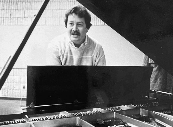 Rick Goward playing the piano in the 1980s.