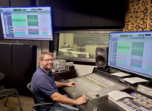 Jeremy Palmer sits at the editing console for the recording arts studio.