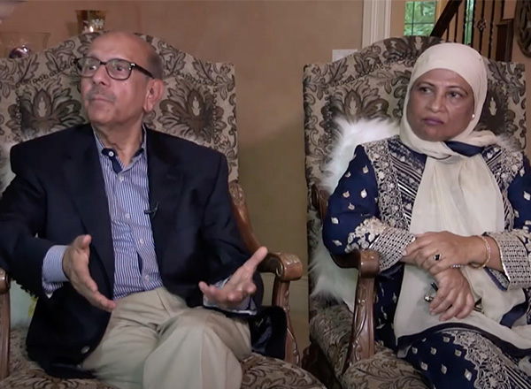 Screenshot of an Indian Muslim couple in America featured in the film, sitting in chairs being interviewed.