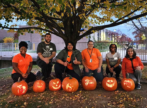 Pumpkin carving artists with their creations.