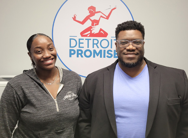 Jerikiah Douglas on the left wearing a grey Henry Ford College hoodie and Mark Yancy on the right in a black blazer and blue T-shirt in front of the Detroit Promise logo.