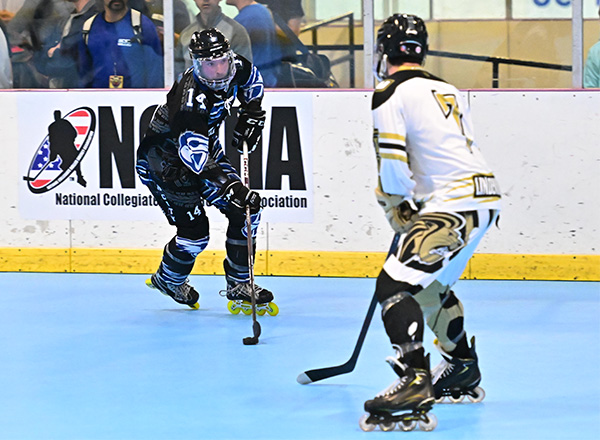 Hawks roller hockey player Dustin Foran playing against an opposing player.