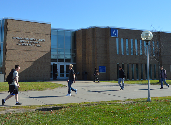 Students walking past the Learning Success Center on a sunny day. 
