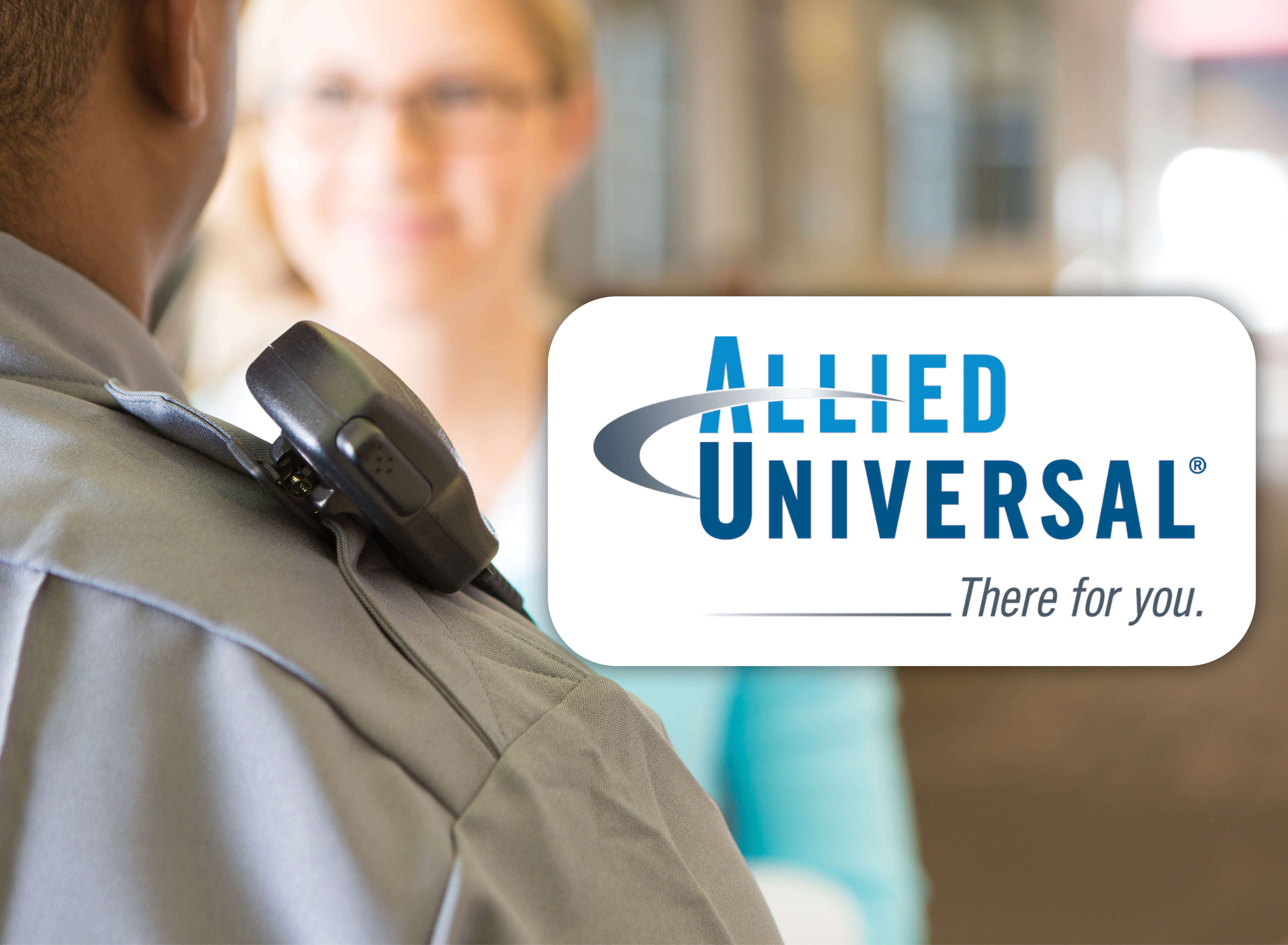 A security officer speaking with a student in the background, next to the Allied Universal logo.