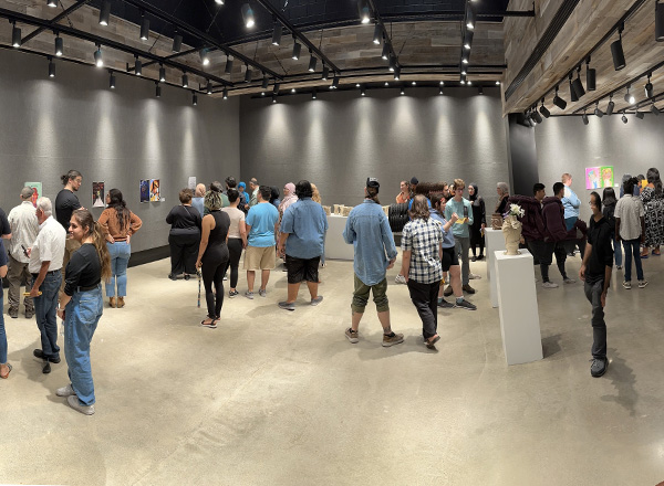 Panoramic shot of students in the Sisson Art Gallery. 