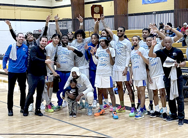 Image of men's basketball team after they won the District championship, March 2023.