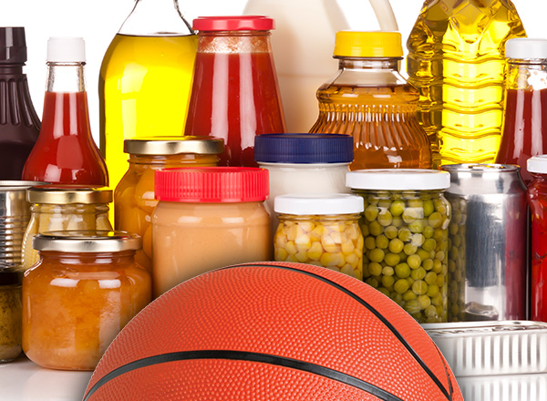 Photo showing a variety of non-perishable food with part of a basketball along the bottom edge.