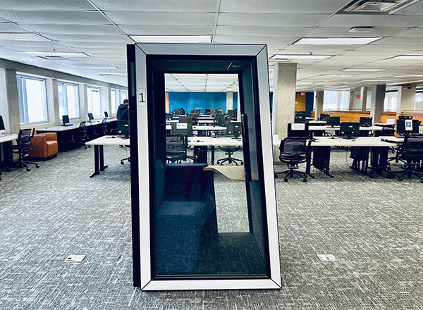 The library pod sits in the upstairs portion of the library. It is a soundproof case with a cushioned bench and ledge to place a book or laptop. 