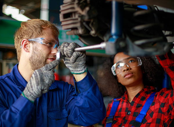 Two students working on a car