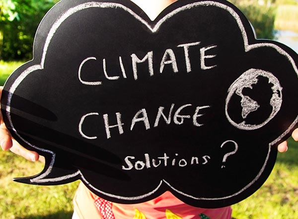 An image of a chalkboard speech bubble that reads "Climate Change Solutions?"