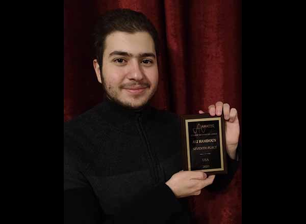 HFC pre-engineering student Ali Hamdoun proudly shows off his trophy. Hamdoun recently took 7th place nationally in the Student Mathematics League (SML) Competition.