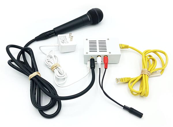 An image of a jack trip device (cords and a microphone) which will allow musicians to rehearse virtually. 