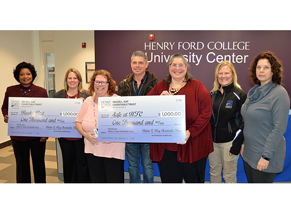 Group shot of employees holding up their $1,000 checks 