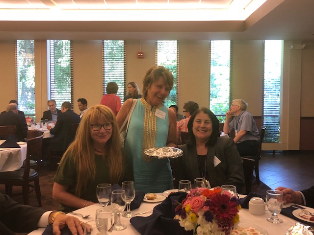 People sitting and standing near a table