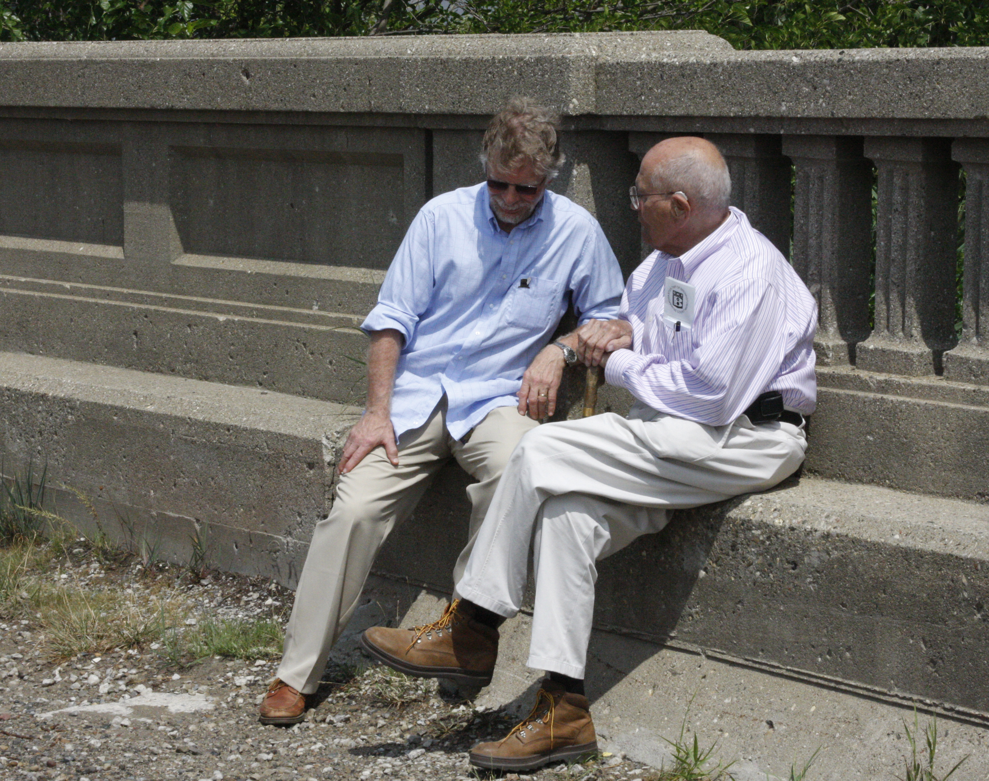 Daniel Harrison sitting on a bench talking to John Dingell