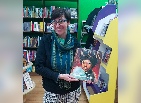 HFC alumna/Green Brain Comics co-owner Katie Merritt shows off her award given to her Dearborn-based comics store by Hour Detroit Magazine. Readers voted Green Brain "Hour Detroit's Best of Detroit Comic Book Store – Single Location.”  To make this award