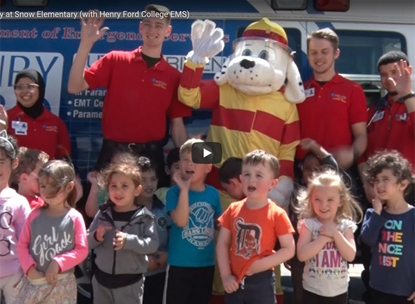 Photo of HFC students and Sparky the Fire Dog with Snow Elementary students.