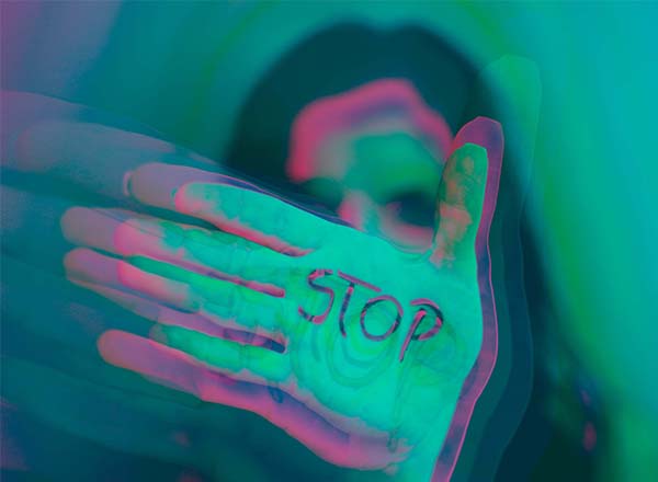 Hand with the word stop printed on the palm.