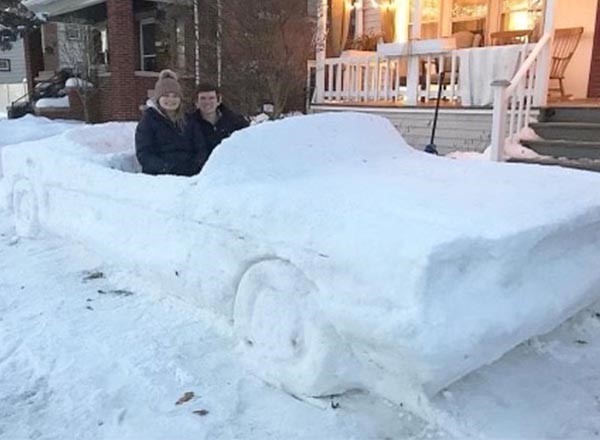 Jacob DiMaria (right) takes his wife Lizzie (left) for a "spin" in his 1965 Ford Mustang sculpture a few years ago. 
