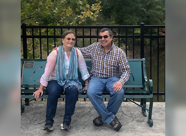 Mary Lane and husband sitting on bench. 
