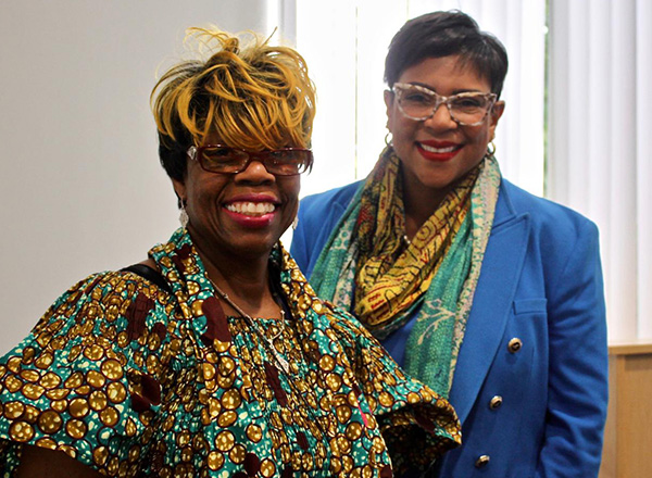 Sen. Sylvania Santana (right) poses for a photo with an attendee. 