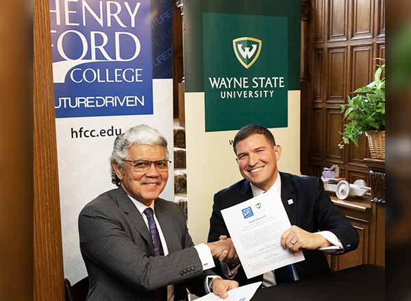 Wayne State University and Henry Ford College Presidents shaking hands after signing Learn4ward partnership.