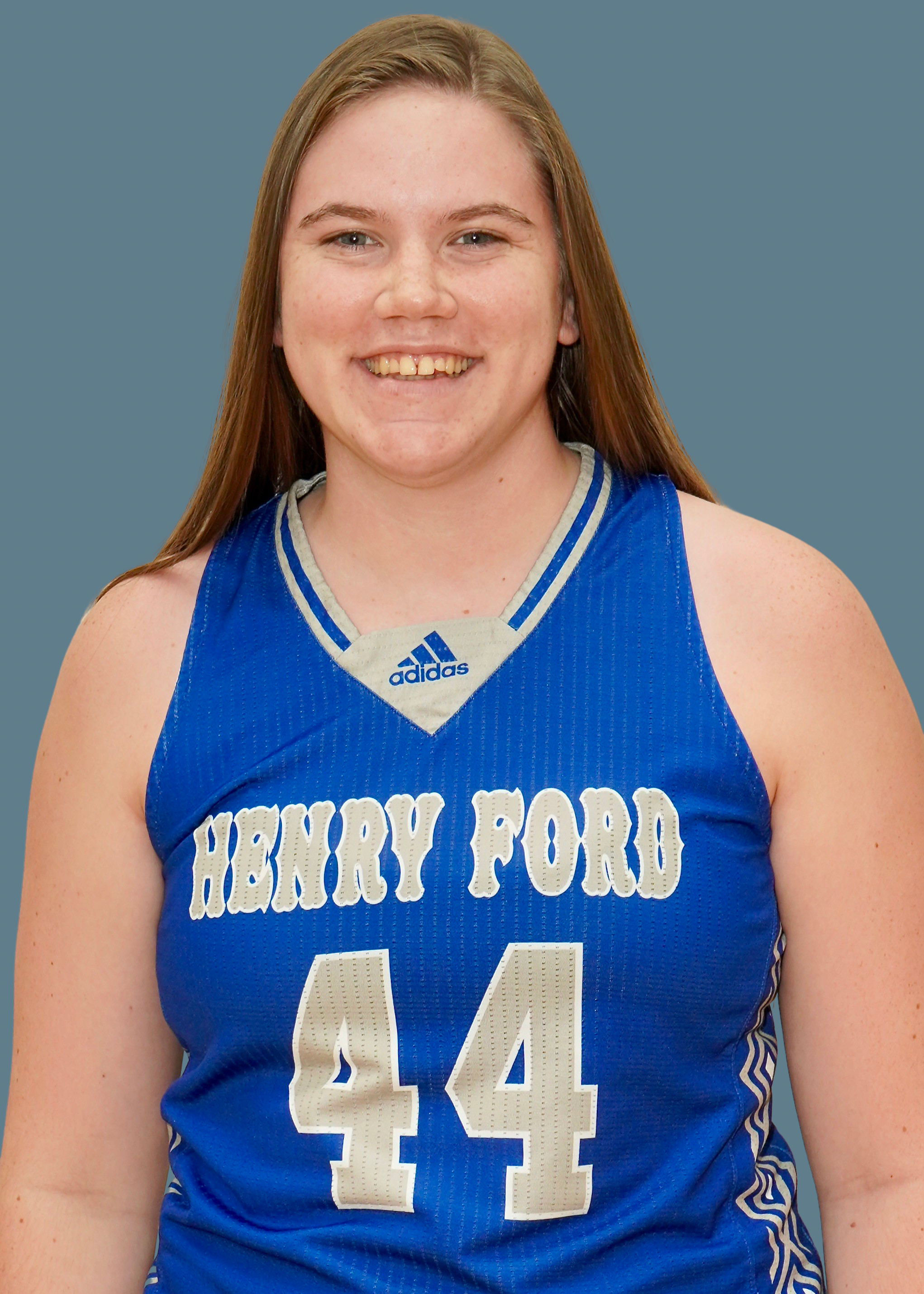 Portrait of Faith Plummer in blue Henry Ford jersey on blue background