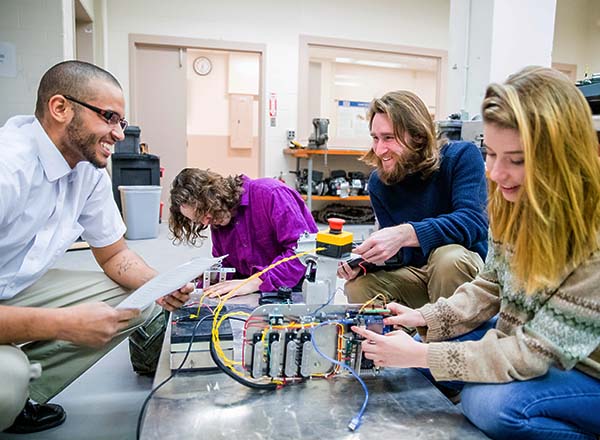 Students working on robotic parts