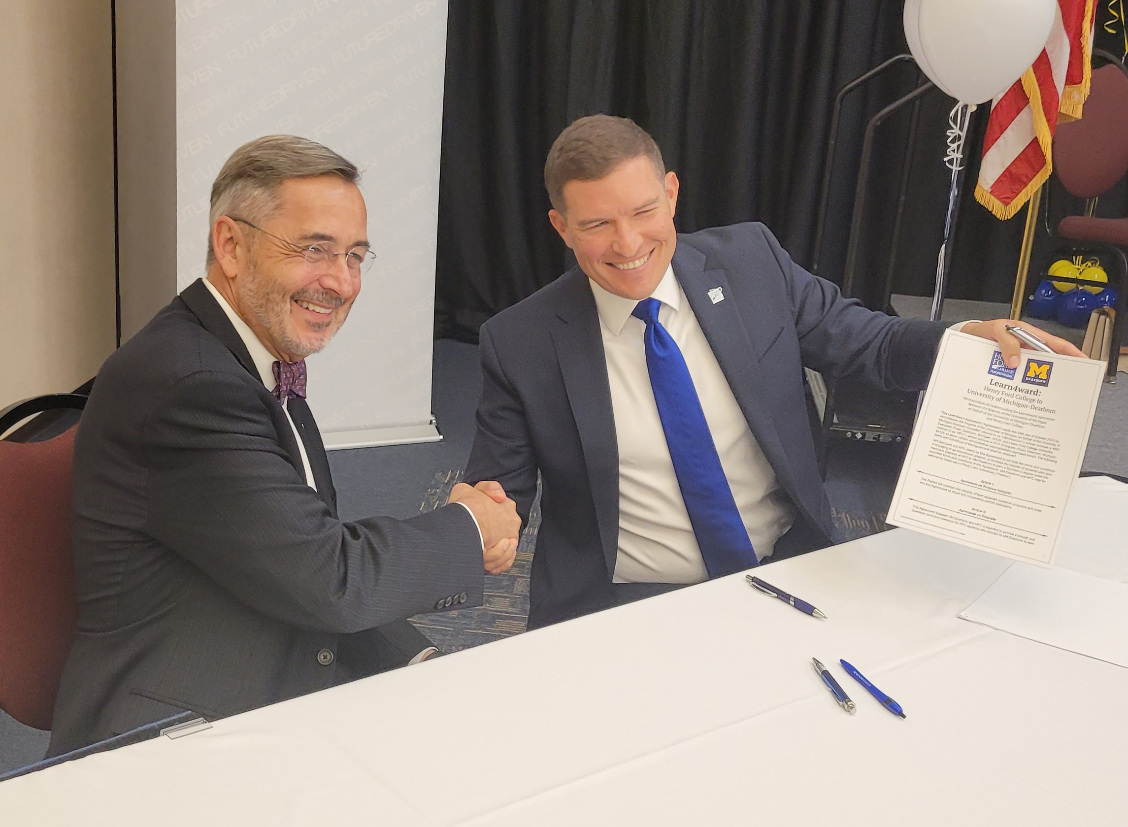 Kavalhuna and Grasso sign the agreement. (Photo by HFC staff)