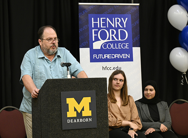HFC student Mark Robey at the podium. Fellow students Alayna Kondraciuk and Zena Sattar, seated, also spoke. 