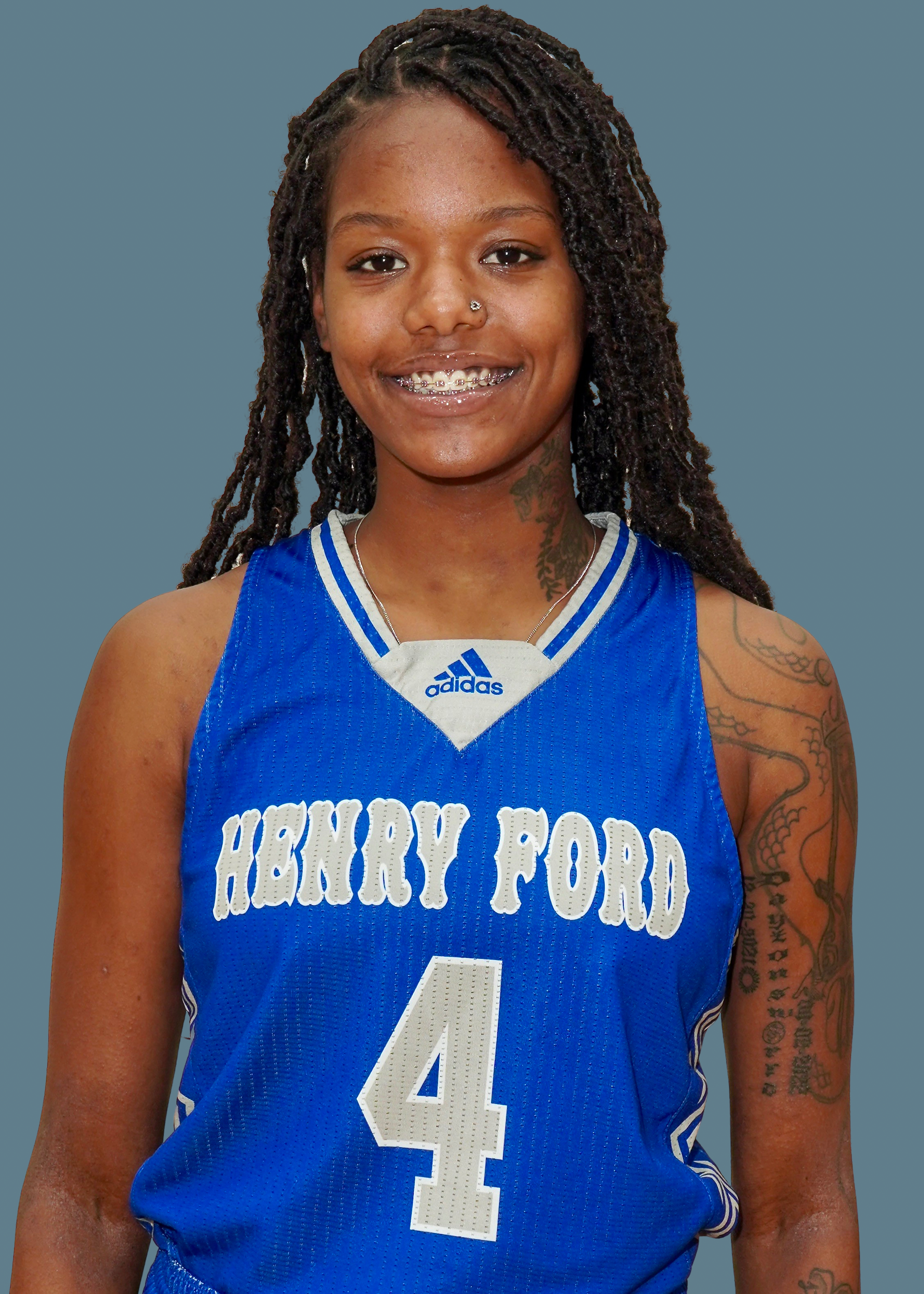 Portrait of Tiajah Lewis in blue Henry Ford jersey on blue background